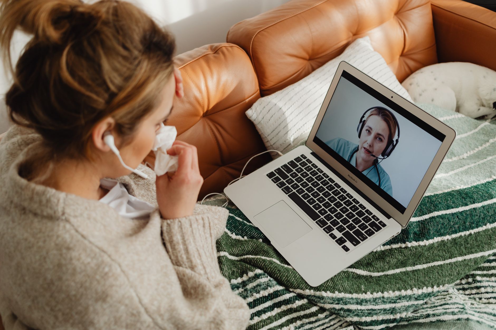 A person meeting their therapist by video from a calm room at home in California